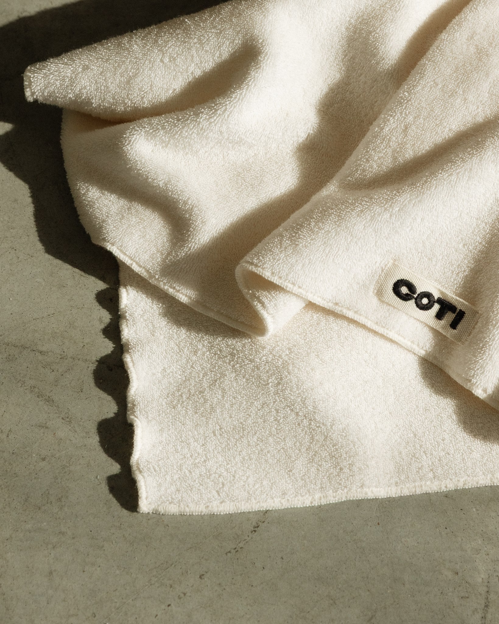 Folded COTI hair towel with visible woven label